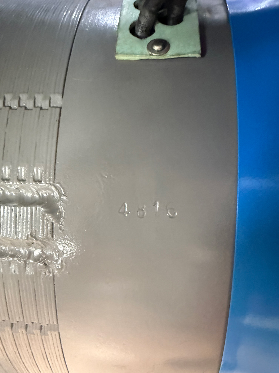 Close-up of stamped code on stator housing